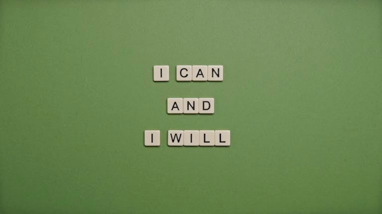 Inspirational message 'I Can and I Will' spelled with tile letters on a green background.